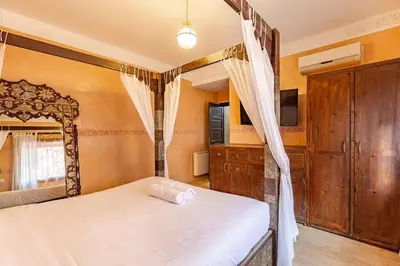 a bedroom with a white bed and a mirror at New! Apt jacaranda, wifi and parking in Marrakech