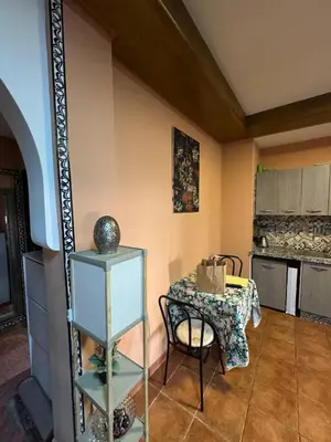 a kitchen with a table and a table and a chair at Dream stay 5 swimming pools for family in Marrakech