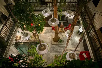 an overhead view of a building with plants and lights at Riad O'Zeen in Marrakech