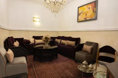 a living room with couches and a chandelier at Riad O'Zeen in Marrakech