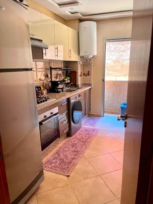 a kitchen with a sink and a dishwasher at Appartement Marrakech 2 chambres Residence al Manar in Marrakech