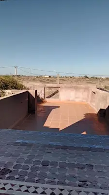 a boardwalk in the middle of the desert at John's Place in Chrabli