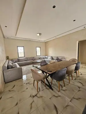 a large living room with a table and a couch at Villa route fes in Marrakech