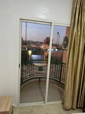 a sliding glass door with a view of a balcony at Le Chaleureux avec Balcon 8 face gare CTM Hivernage in Marrakech