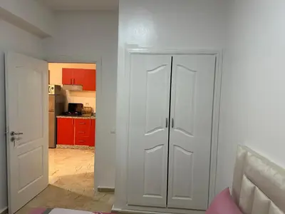 a white closet in a room with a kitchen at Le Chaleureux avec Balcon 8 face gare CTM Hivernage in Marrakech