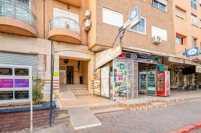 a store on a street in front of a building at Le Chaleureux avec Balcon 8 face gare CTM Hivernage in Marrakech