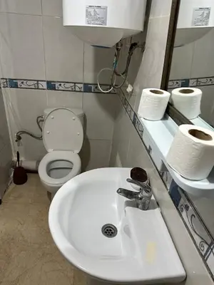 a bathroom with a white sink and a toilet at Le Chaleureux avec Balcon 8 face gare CTM Hivernage in Marrakech
