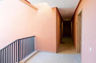 an empty hallway with a staircase in a house at Livia cosy - Clim, Wifi, Jardin à 10min de l'Aéroport in Marrakech
