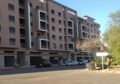a large apartment building with cars parked in front of it at Appart Opera Prestige Détente Moderne in Marrakech
