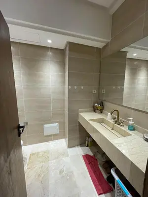 a bathroom with a sink and a mirror at appartement à coté des palmeraies in Marrakech