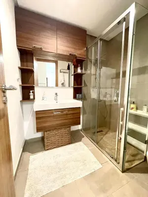 a bathroom with a sink and a shower at Ana cosy - Clim, Wifi, Jardin à 10min de l'Aéroport in Marrakech