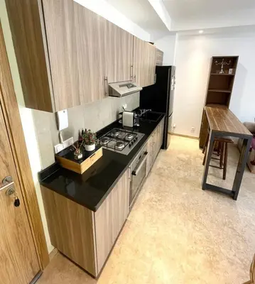 a kitchen with a stove and a counter top at Ana cosy - Clim, Wifi, Jardin à 10min de l'Aéroport in Marrakech