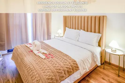 a baby sitting on a bed in a room at Eva cosy - Clim, Wifi, Jardin à 10min de l'Aéroport in Marrakech