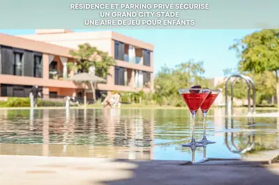 a wine glass sitting in front of a pool of water at Eva cosy - Clim, Wifi, Jardin à 10min de l'Aéroport in Marrakech
