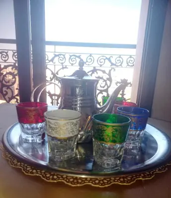 a tray with different colored cups and a tea pot at Charming Oasis in Marrakesh in Marrakech