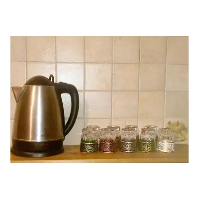 a tea kettle and glasses on a shelf at Charming Oasis in Marrakesh in Marrakech