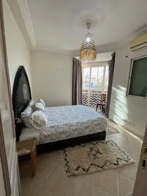 a bedroom with a bed and a chandelier at Dali apartment in Marrakech