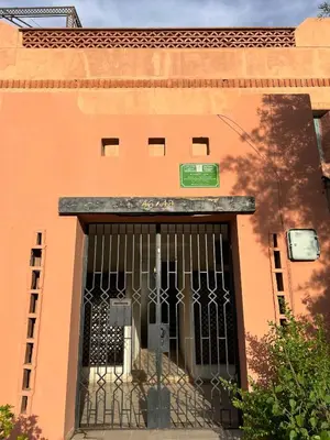 an orange building with a gate in front of it at Dali apartment in Marrakech