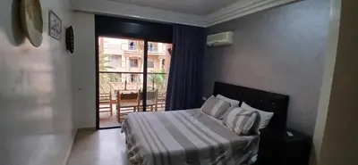 a bedroom with a bed with a view of a balcony at Gueliz apartment 2 chambres Marrakech in Marrakech