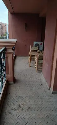 a patio with a table and a bench on a building at Gueliz apartment 2 chambres Marrakech in Marrakech
