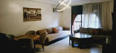 a living room with a couch and a table at Gueliz apartment 2 chambres Marrakech in Marrakech