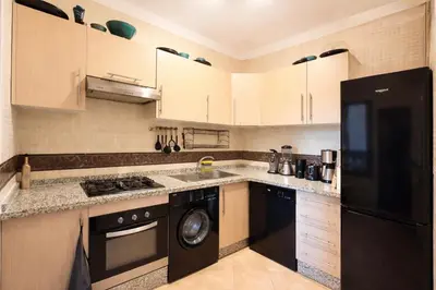 a kitchen with a black refrigerator and a dishwasher at Private Riad Alemania in Marrakesh - Pool - Rooftop in Marrakech