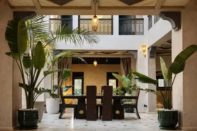 a dining room with a table and potted plants at Private Riad Alemania in Marrakesh - Pool - Rooftop in Marrakech