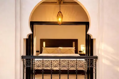 a bedroom with a bed and a chandelier at Private Riad Alemania in Marrakesh - Pool - Rooftop in Marrakech