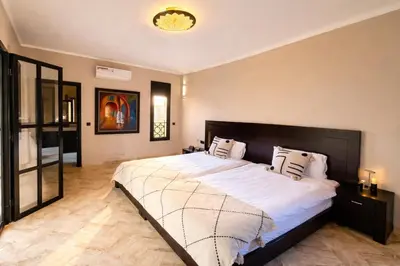 a bedroom with a large bed with white sheets at Private Riad Alemania in Marrakesh - Pool - Rooftop in Marrakech