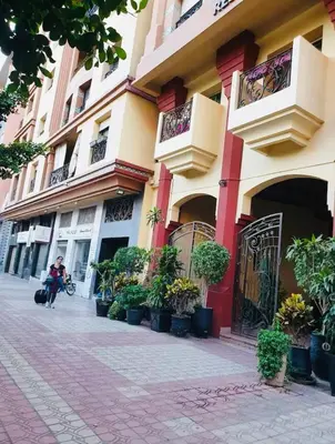 a building with potted plants in front of it at Appartement Centre de Gueliz in Marrakech