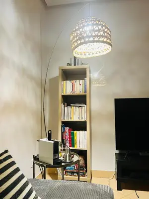 a room with a bed and a book shelf with books at Appartement Centre de Gueliz in Marrakech