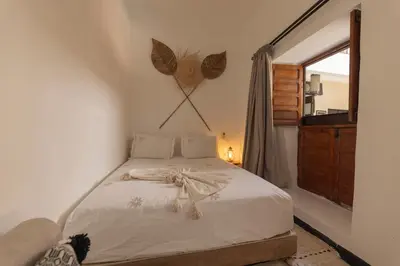 a bedroom with a bed with a bow on it at Riad Dar Bousga in Marrakech