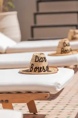 a straw hat sitting on top of a table at Riad Dar Bousga in Marrakech