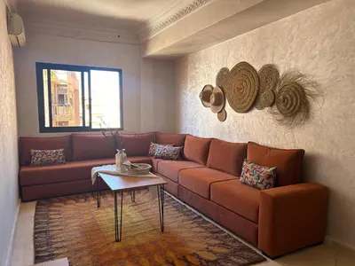 a living room with a couch and a table at Appartement deux chambres a gueliz in Marrakech