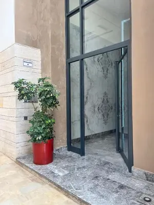 two potted plants sitting in front of a glass door at Mama cosy - Clim, Wifi, Piscine en centre ville in Marrakech