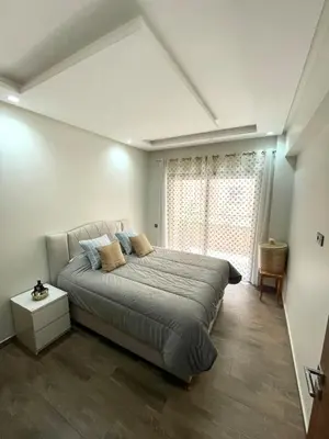a bedroom with a large bed and a window at Mama cosy - Clim, Wifi, Piscine en centre ville in Marrakech