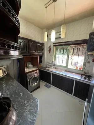 a kitchen with a sink and a washing machine at Appartement familiale et traditionnel in Marrakech