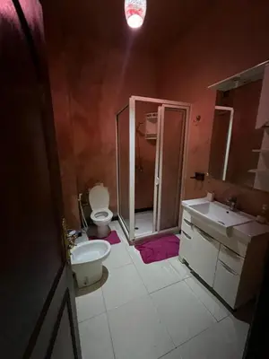 a bathroom with a toilet and a sink and a shower at Appartement familiale et traditionnel in Marrakech