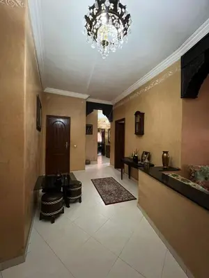 a large hallway with a chandelier and a room at Appartement familiale et traditionnel in Marrakech