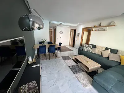 a living room with a couch and a table at Appartement familial in Marrakech