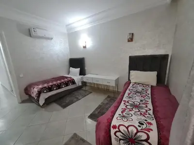 a bedroom with two beds in a room at résidence ATLASS in Marrakech