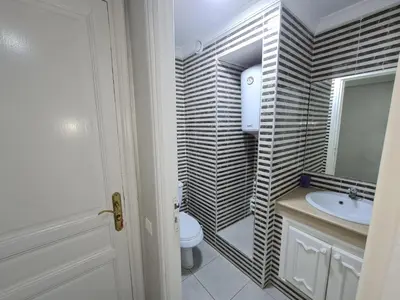 a bathroom with a toilet and a sink and a mirror at résidence ATLASS in Marrakech