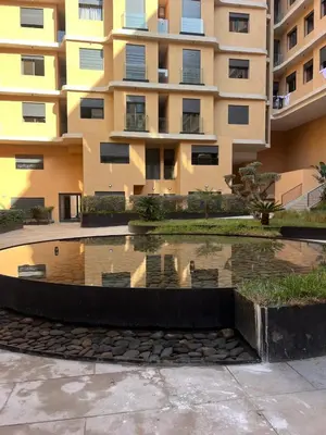 a building with a pool of water in front of a building at elite garden appartment in Marrakech