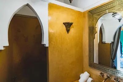 a bathroom with a mirror and a sink at Riad El Ayadi, Moorish villa in Marrakech