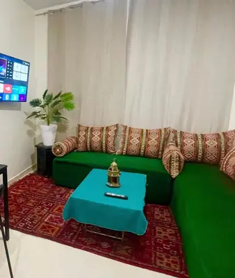 a green couch in a living room with a table at Medina Marrakech Life in Marrakech