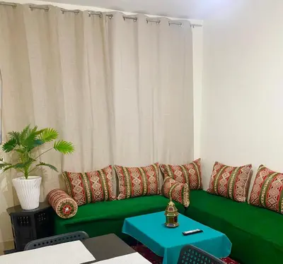 a green couch with pillows in a living room at Medina Marrakech Life in Marrakech
