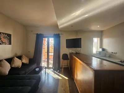a living room with a couch and a window at Résidence la paix in Marrakech