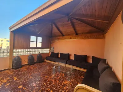 a large living room with couches and a table at Résidence la paix in Marrakech