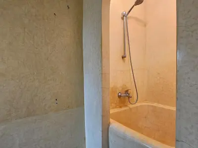 a bathroom with a bath tub with a shower at Résidence la paix in Marrakech