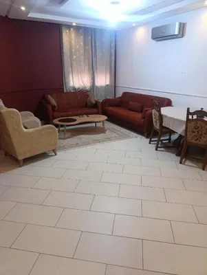 a living room with couches and a table and chairs at Studio lumineux pour location journalière in Marrakech